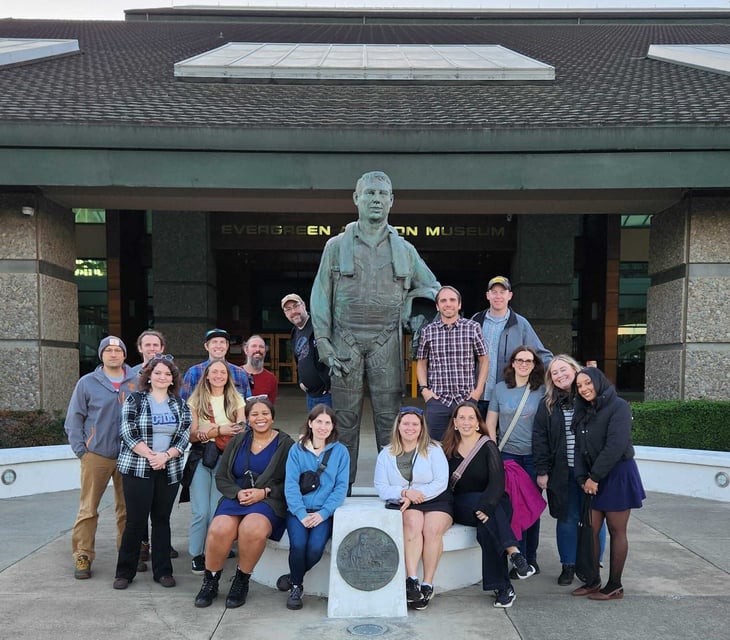 Group photo of dymaptic team outside a Evergreen Aviation & Space Museum