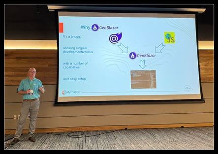 Tim Rawson presenting on GeoBlazor at the GIS in Action conference, with a GeoBlazor slide